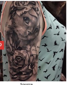 a woman with a cat and roses tattoo on her arm