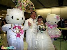 a bride and groom pose with hello kitty