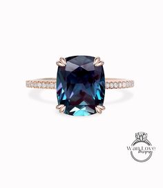 a cushion cut blue sapphire ring with diamonds on the band and an 18k rose gold band