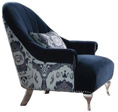 an upholstered chair with blue and white fabric