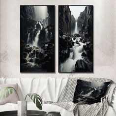 two black and white paintings hanging on the wall above a couch in a living room