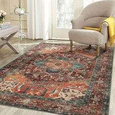 a living room area with a chair, rug and table in front of a window