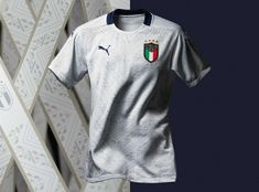 a soccer jersey hanging on a wall next to a window with an italian flag painted on it