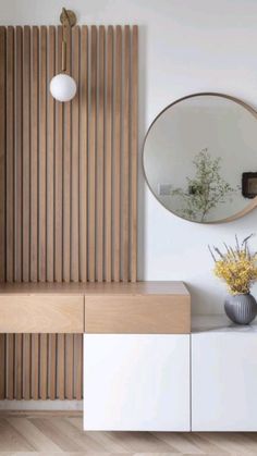 a vase with yellow flowers sitting on top of a white cabinet next to a mirror