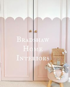 a pink door with the words, bradshaw home interiors on it and a chair in front