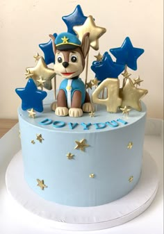 a birthday cake with a dog and stars on it