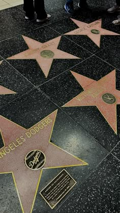 the hollywood walk of fame stars are lined up on the floor with names and symbols