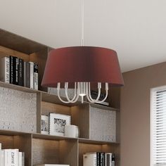 a lamp hanging over a book shelf filled with books