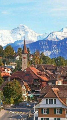 a town with mountains in the background and snow on the top of the mountain range