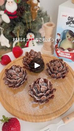 an image of some food on a wooden platter with strawberries and christmas tree in the background