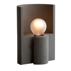 a light that is on top of a cement block with a white ball in it