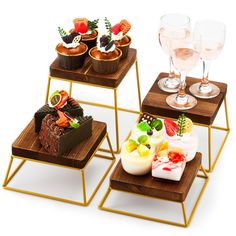 three wooden trays with different types of desserts on them and wine glasses in the background