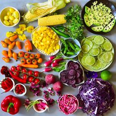 a table topped with lots of different types of vegetables next to bowls of fruit and veggies