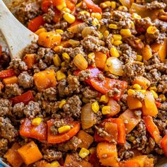 a large pot filled with ground beef and vegetables