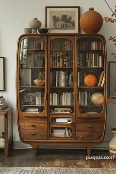 an old bookcase with many books and vases sitting on it's sides