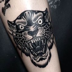 a black and white tiger tattoo on the leg