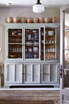 an old china cabinet with glass doors