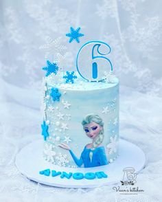 a frozen princess themed birthday cake with the number six on top