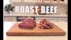 a wooden cutting board topped with meat on top of a kitchen counter