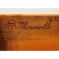 a wooden sign that reads thomasville on it's side, with the word thomasville in cursive writing