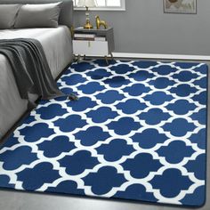 a blue and white rug in a bedroom