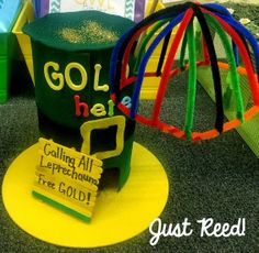 there is a green and yellow hat on top of a play ground with other toys in the background