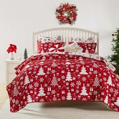 a red and white christmas themed bed in a bedroom