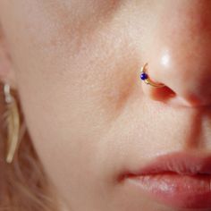 a close up of a person with a nose piercing on their left side of the face