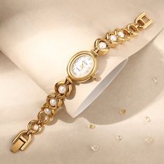 Are you ready to attract everyone's envious gaze? This vintage gold pearl women's watch is like a piece of jewelry in a classic movie, instantly making you the focus of the audience. The golden dial is like the autumn sun, and the pearl-like decoration shines with charming light. Every gaze is like a dialogue with time. The most special thing is that this watch is customized with a name and is purely handmade! 👀 Warm Tips: The watch can be resized by linking the disassembly tool (the disassembl Metal Watches With Bracelet Strap, Metal Watch Accessories With Round Dial For Gift, Metal Watch With Bracelet Strap, Metal Watches Suitable For Gifts, Metal Watches With Round Dial For Gift, Metal Watch With Round Dial For Gift, Metal Watches Gift, Metal Analog Watches With Adjustable Fit, Adjustable Metal Analog Watches