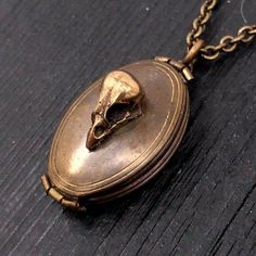 "This solid brass locket has been aged inside and out to give it a beautiful vintage patina. Measuring 1-1/8\" long by 13/16\" wide, the double locket opens up like an accordion providing ample room inside for four descent size images of those dear you, be they near or departed, pets included. The front of the locket is adorned with my tiny baby skull made of solid bronze. The back of the locket is adorned with an attractive fish scale design. The matching bronze soldered link chain is fitted wi Old Locket Aesthetic, Gothic Locket, Black Rose Ring, Baby Skull, Palm Necklace, Victorian Gothic Jewelry, Edwardian Necklace, Unique Locket, Victorian Style Jewelry