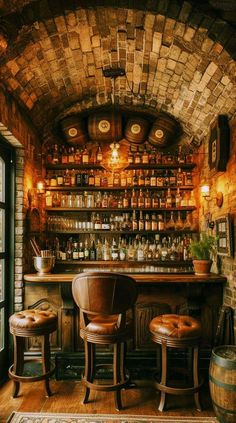 an old fashioned bar with stools and bottles on the shelves