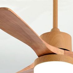 a ceiling fan with wooden blades and a light on the bottom one side is turned upside down