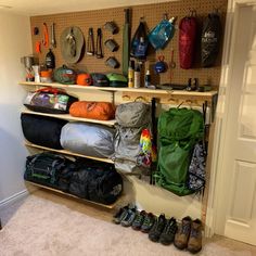 there are many bags and backpacks on the shelves in this room that is filled with sports gear