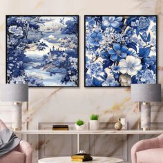 two blue and white paintings on the wall in a living room with pink chairs, tables and lamps