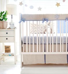 a baby crib with blue and white decor