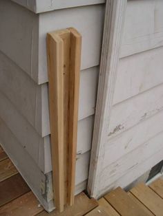 the corner of a house that has been boarded off with wood sticking out from it