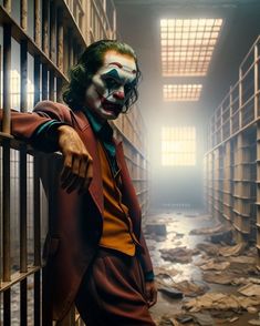 the joker is standing in a jail cell with his hands on the bars and looking at the camera