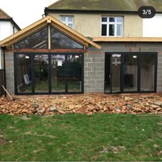 an image of a house being built in the back yard with wood chips piled on the ground