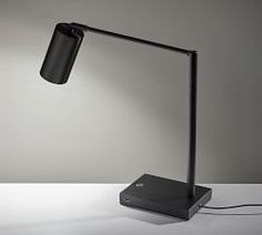 a desk lamp with a black shade on it