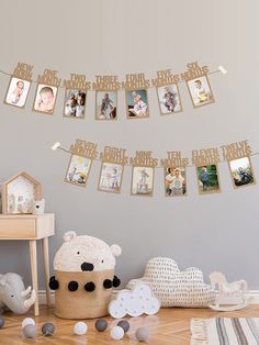 a baby's room with pictures hanging from the wall and toys on the floor