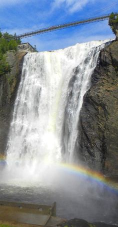 a large waterfall with a rainbow in the middle