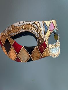 This Venetian style mask in red, black, and gold is perfect for any formal occasion or masquerade event! Thank you for supporting small businesses and hope our products bring you and loved ones some joy and humor in these trying times.    I N C L U D E D Masks come with matching double sided satin ribbons attached. S I Z E  Adult size. Detailed dimensions available upon request. C U S T O M I Z A T I O N If you would like to color & embellish the mask to match your costume/dress, choose custom color and get in touch, we love to work on custom orders!  C O N T A C T  Please contact us via ETSY messages. P H O T O  Images displayed on this listing are property of www.higginscreek.com A B O U T HigginsCreek makes elegant face Masks for masquerade balls, Prom Dances, Bachelorette parties, Grad Masquerade Event, Harlequin Mask, Elegant Face Mask, Elegant Face, Mask Venetian, Mens Masquerade Mask, Venetian Masquerade Masks, Metal Mask, Masked Ball