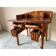 a wooden table with two chairs and drawers