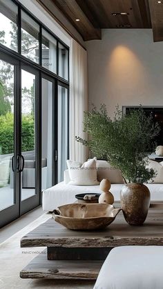 a living room filled with furniture and a fire place in the middle of an open floor plan