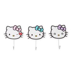 three hello kitty pins with bows on them