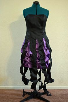 a black and purple dress on a mannequin