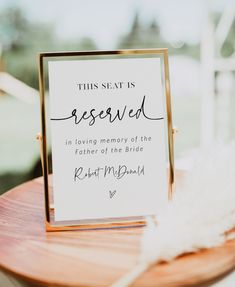 a sign that says this seat is reserved in loving memory of the father of the bride