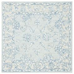 a blue and white rug with an intricate design on the bottom, in front of a white background