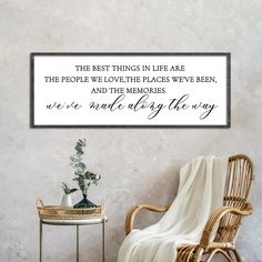 a chair and table in front of a wall with a quote on it that says, the best things in life are the people we love the places we've