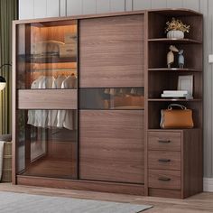 an open closet with glass doors and drawers in a living room next to a window